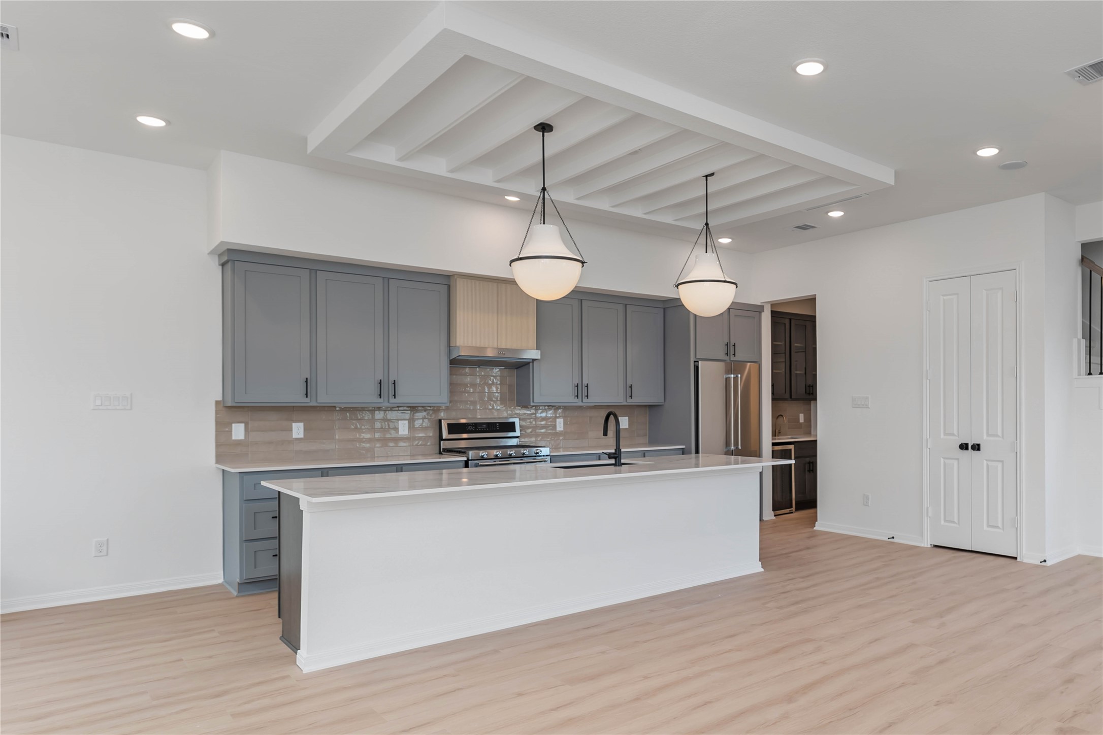 3508 Delhi Street Houston, TX 77022 - Photo 9 of 38 a large kitchen with stainless steel appliances granite countertop a sink a stove and a refrigerator