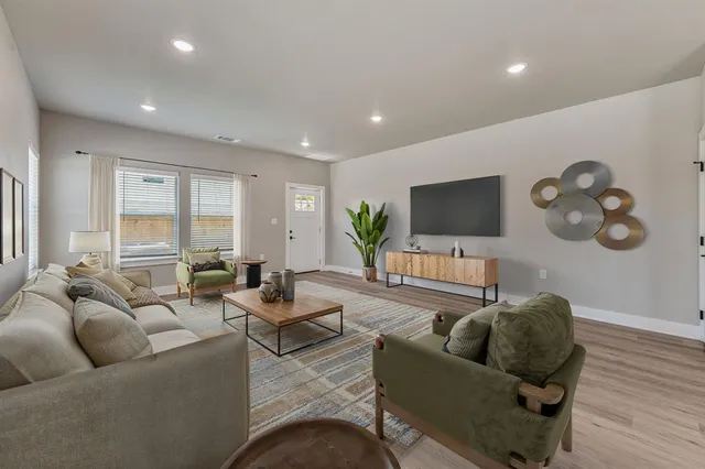 a living room with furniture and a flat screen tv