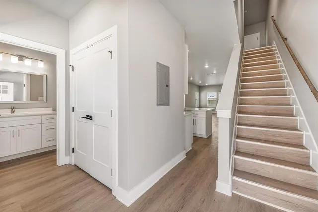 a view of a hallway with wooden floor and entryway
