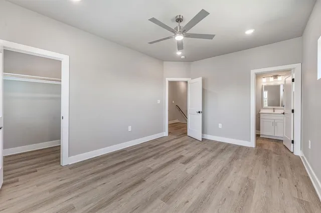 an empty room with wooden floor and mirror