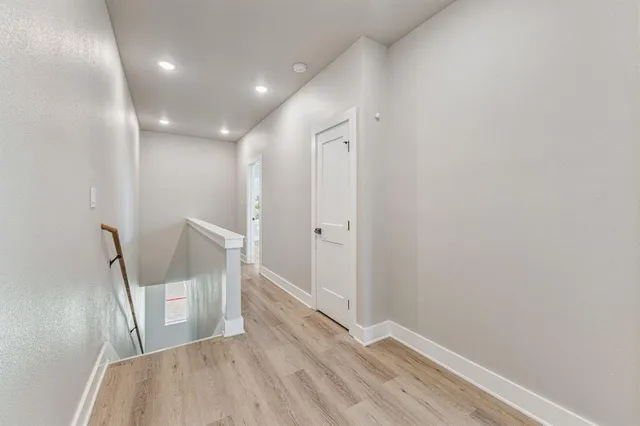 a view of a hallway and wooden floor