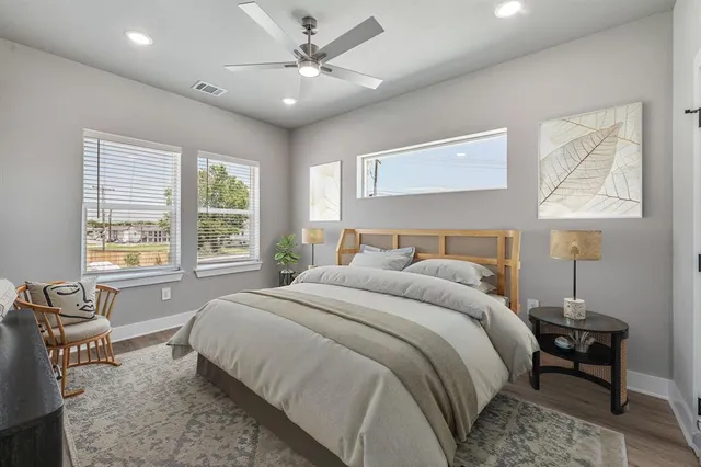 a bedroom with a large bed and a chandelier