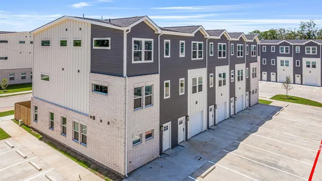 a view of a house with wooden fence