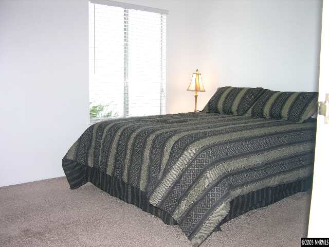 400 South Saliman Road, Unit 47 Carson City, NV 89701 - Photo 4 of 9 a bed sitting in a bedroom next to a window