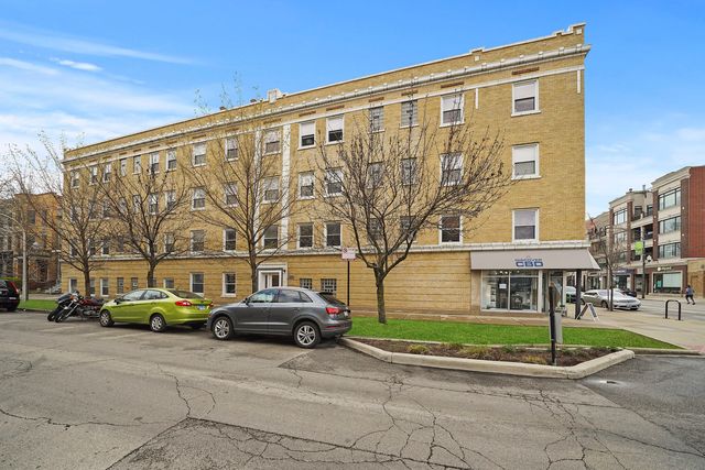 a view of a parked cars in front of a building