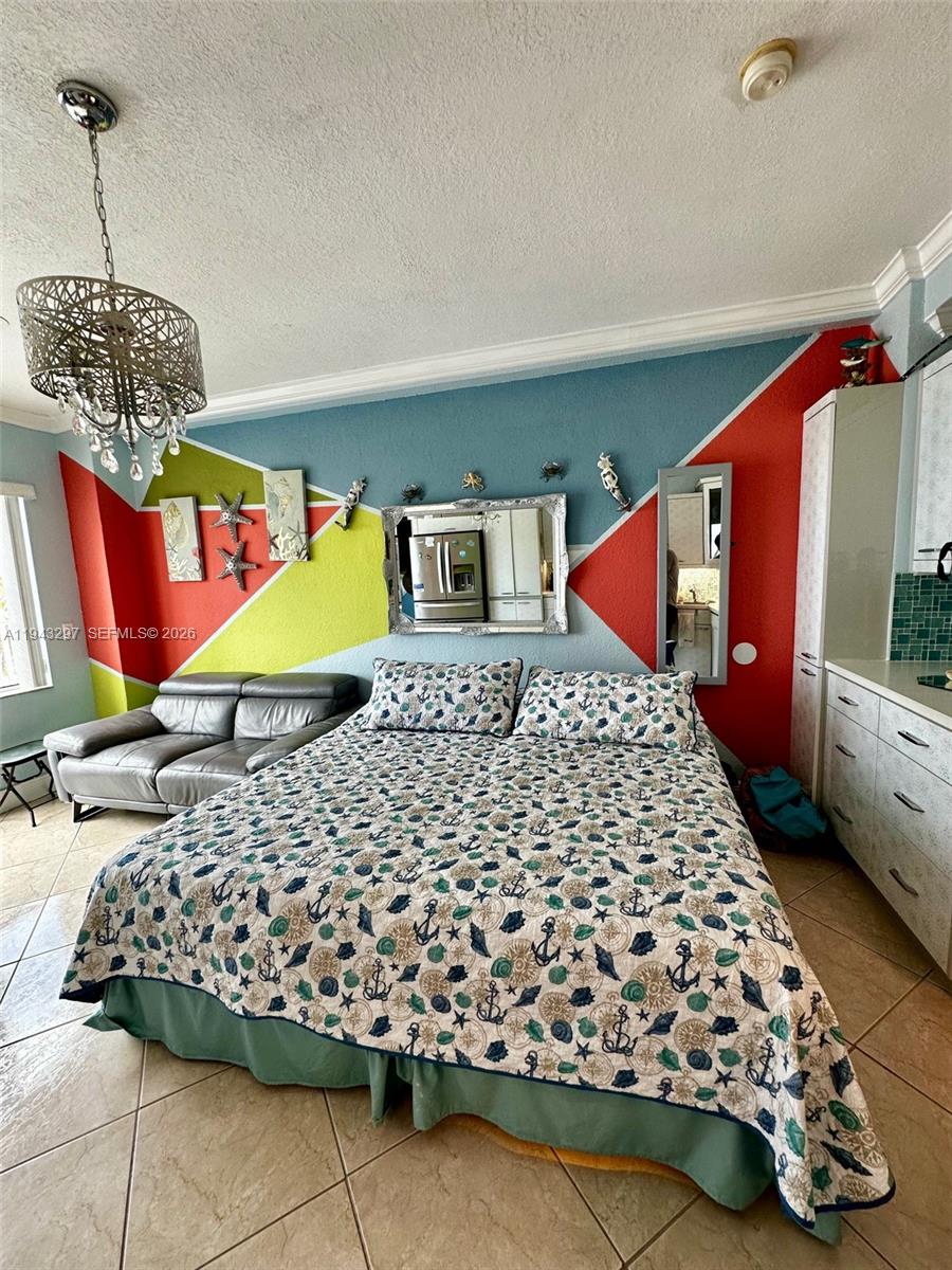 6345 Collins Avenue, Unit 435 Miami Beach, FL 33141 - Photo 12 of 28 a bedroom with a bed and window