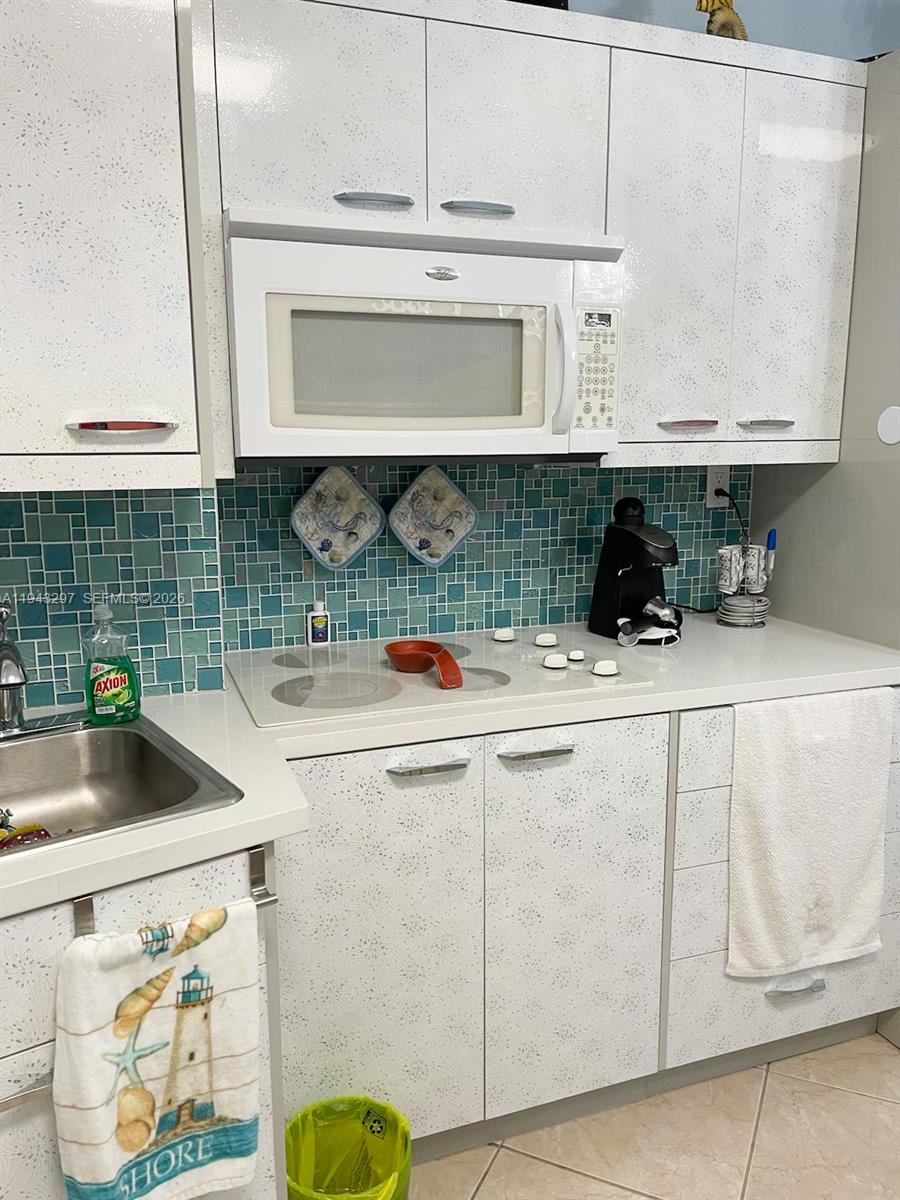 6345 Collins Avenue, Unit 435 Miami Beach, FL 33141 - Photo 15 of 28 a kitchen with a sink and cabinets