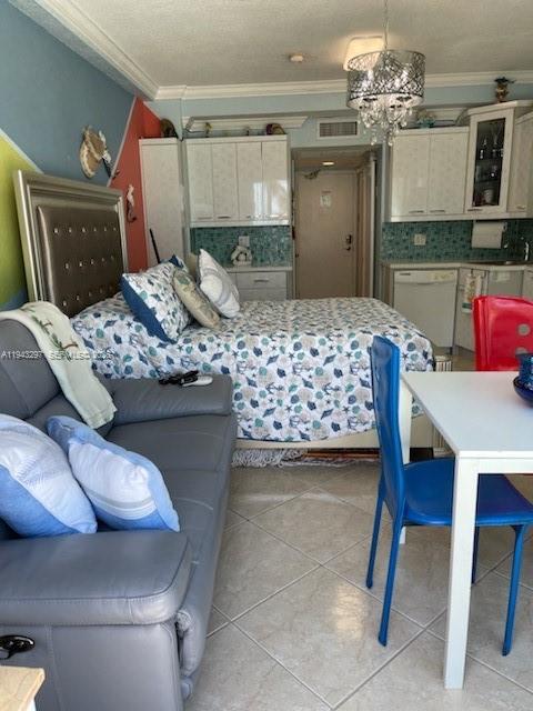 6345 Collins Avenue, Unit 435 Miami Beach, FL 33141 - Photo 20 of 28 a bedroom with a bed and a chandelier