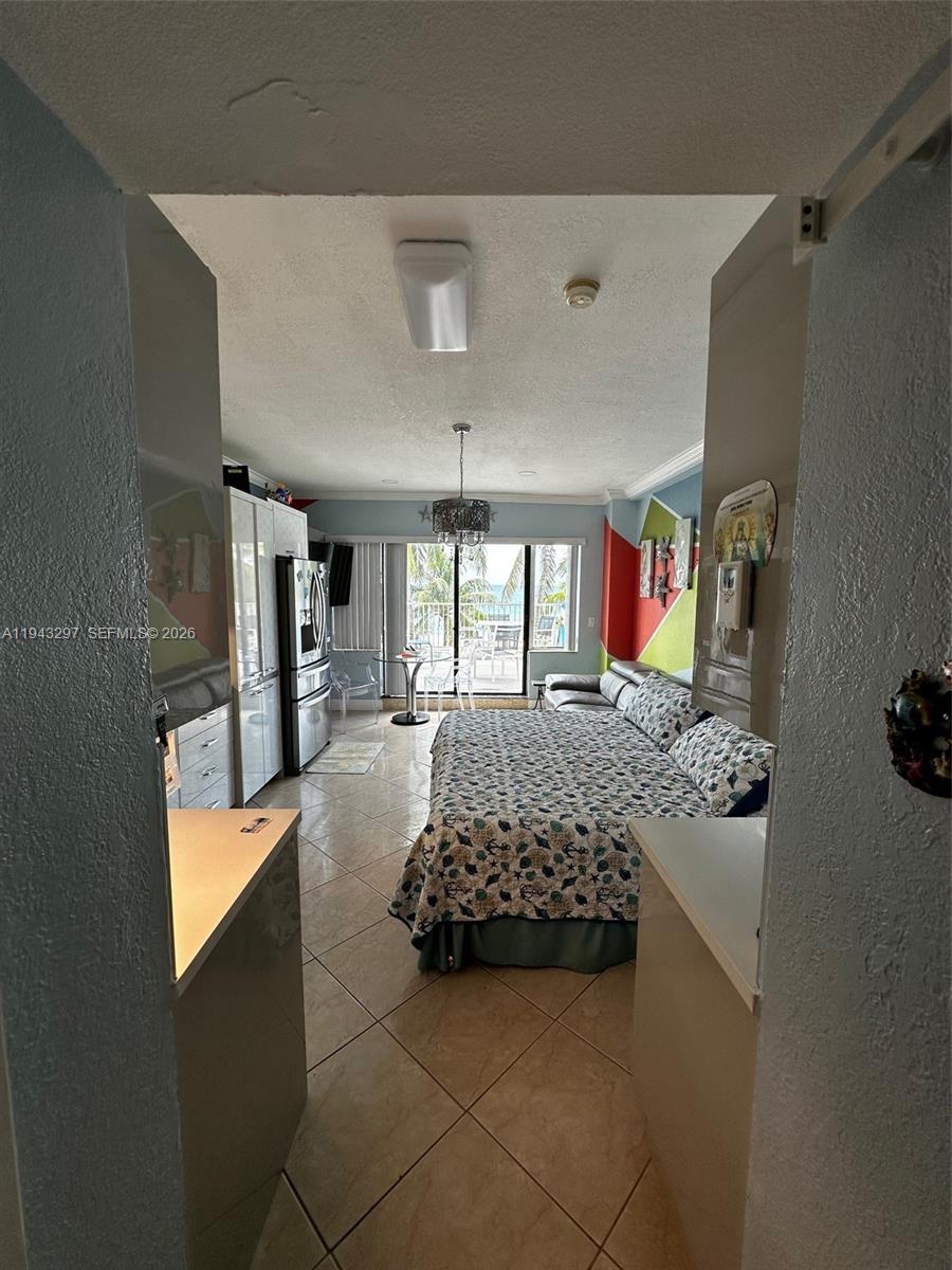 6345 Collins Avenue, Unit 435 Miami Beach, FL 33141 - Photo 10 of 28 a bed room with a bed window and flat screen tv