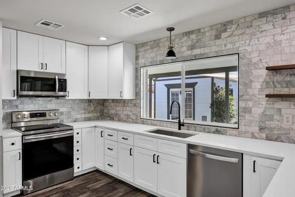 a kitchen with granite countertop a stove and a sink