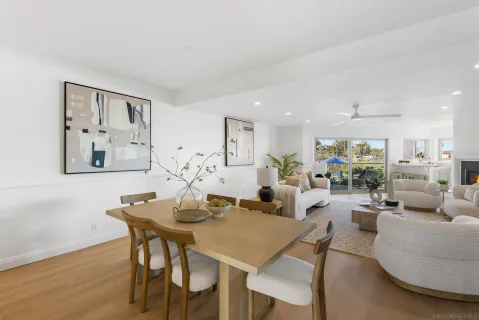a living room with furniture a fireplace and a large window