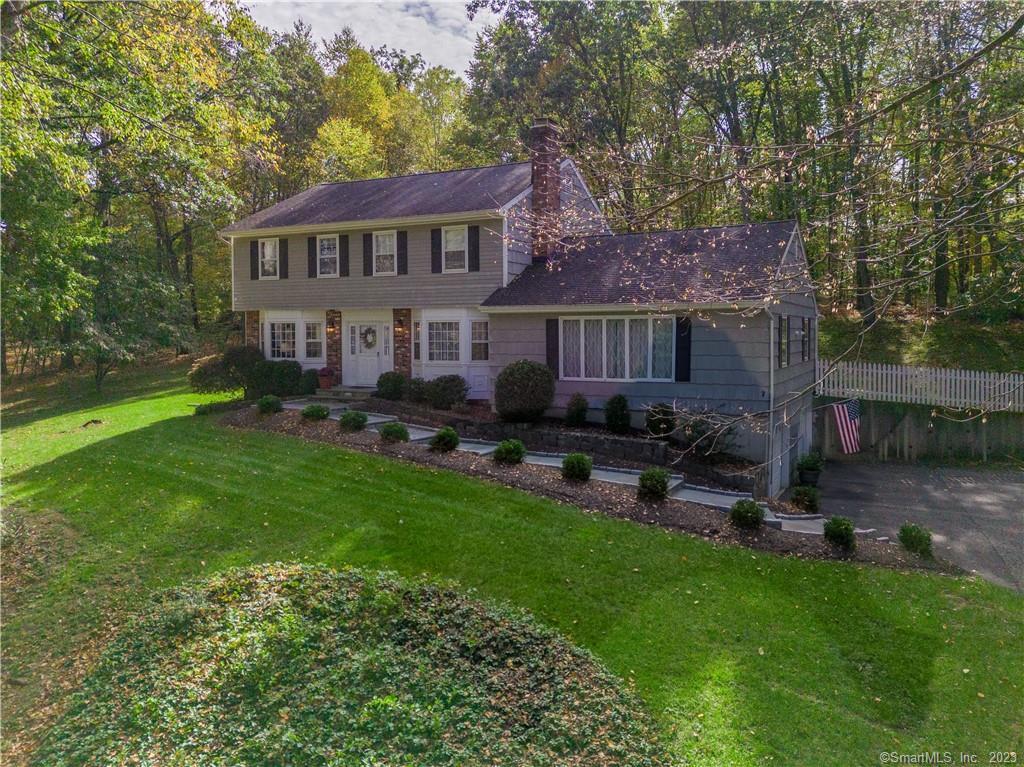 a view of a house with backyard sitting area and garden