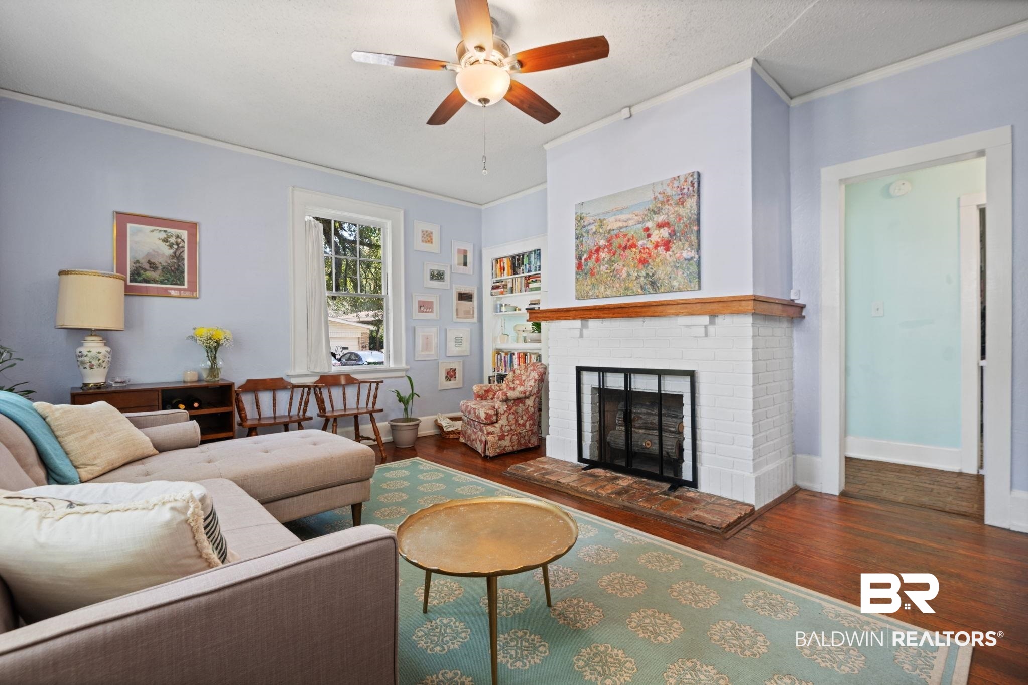324 4th Street Mobile, AL 36611 - Photo 12 of 28 Living room featuring ornamental molding, a brick fireplace, dark hardwood / wood-style floors, a textured ceiling, and ceiling fan