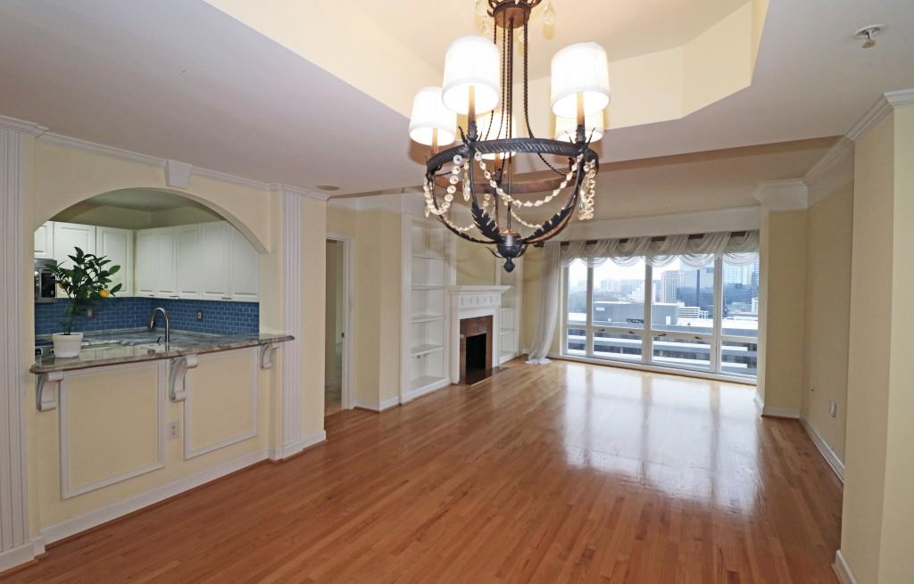 a very nice looking kitchen with a wooden floor and chandelier