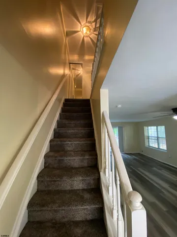 a view of an empty room and wooden floor