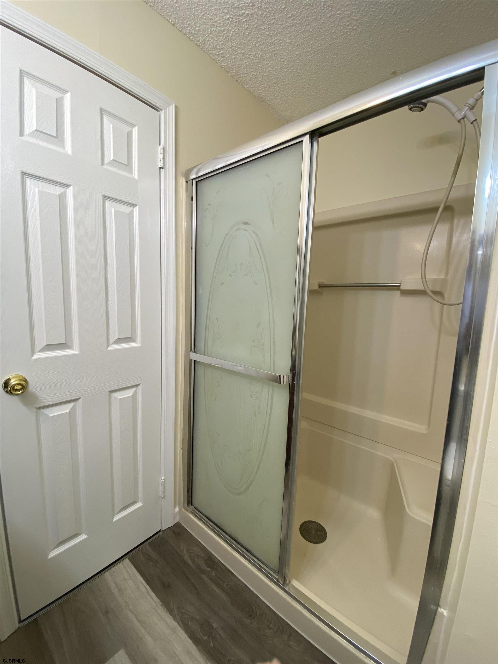 66 Shawnee Place, Unit 66 Galloway Township, NJ 08205 - Photo 14 of 20 a bathroom with a glass shower door