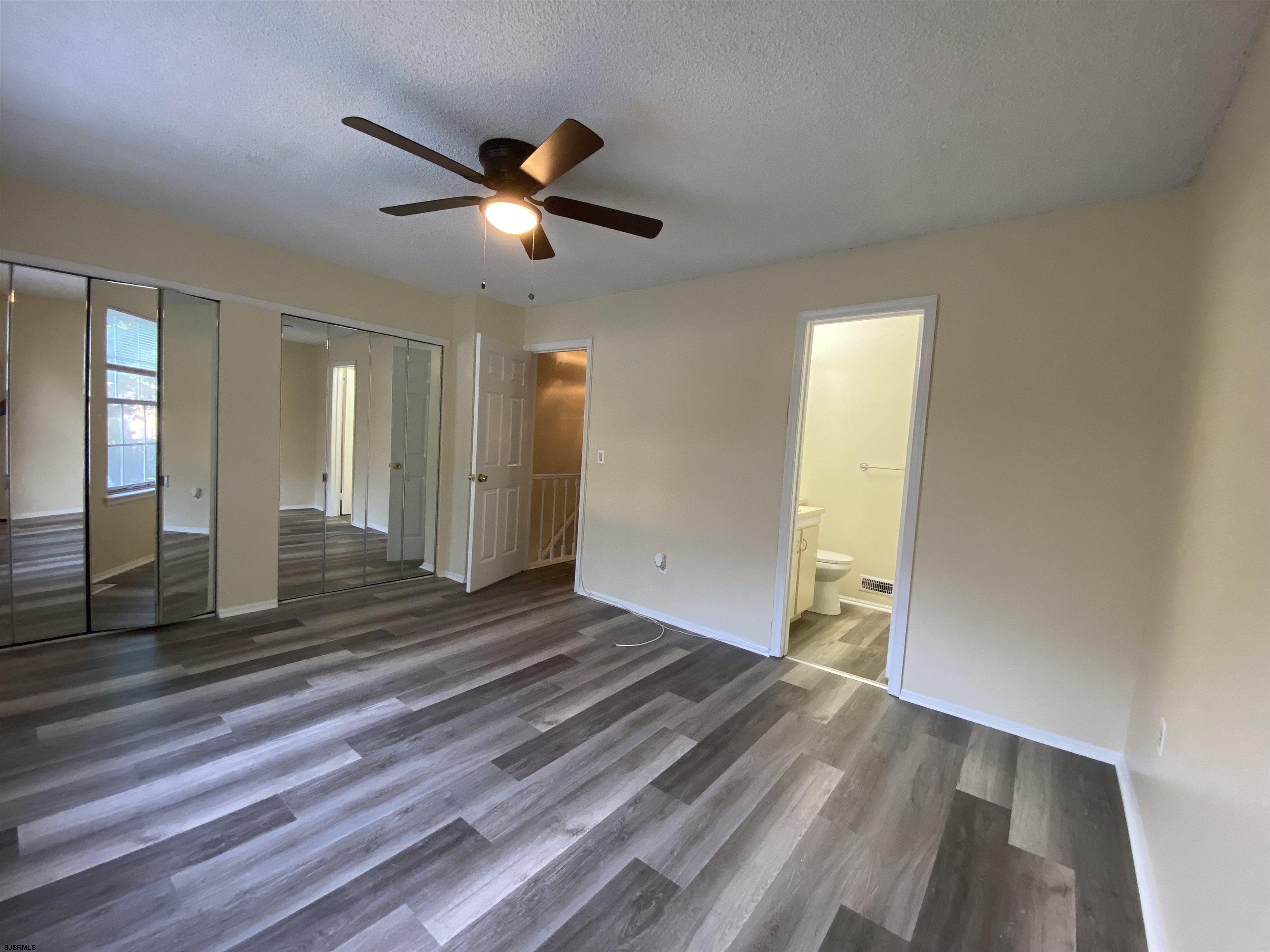 66 Shawnee Place, Unit 66 Galloway Township, NJ 08205 - Photo 16 of 20 a view of a livingroom with a hall and wooden floor