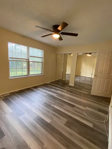 a bathroom with a granite countertop sink toilet and a mirror