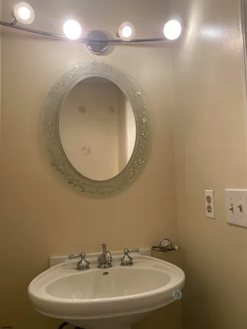 a bathroom with a sink a mirror and a toilet