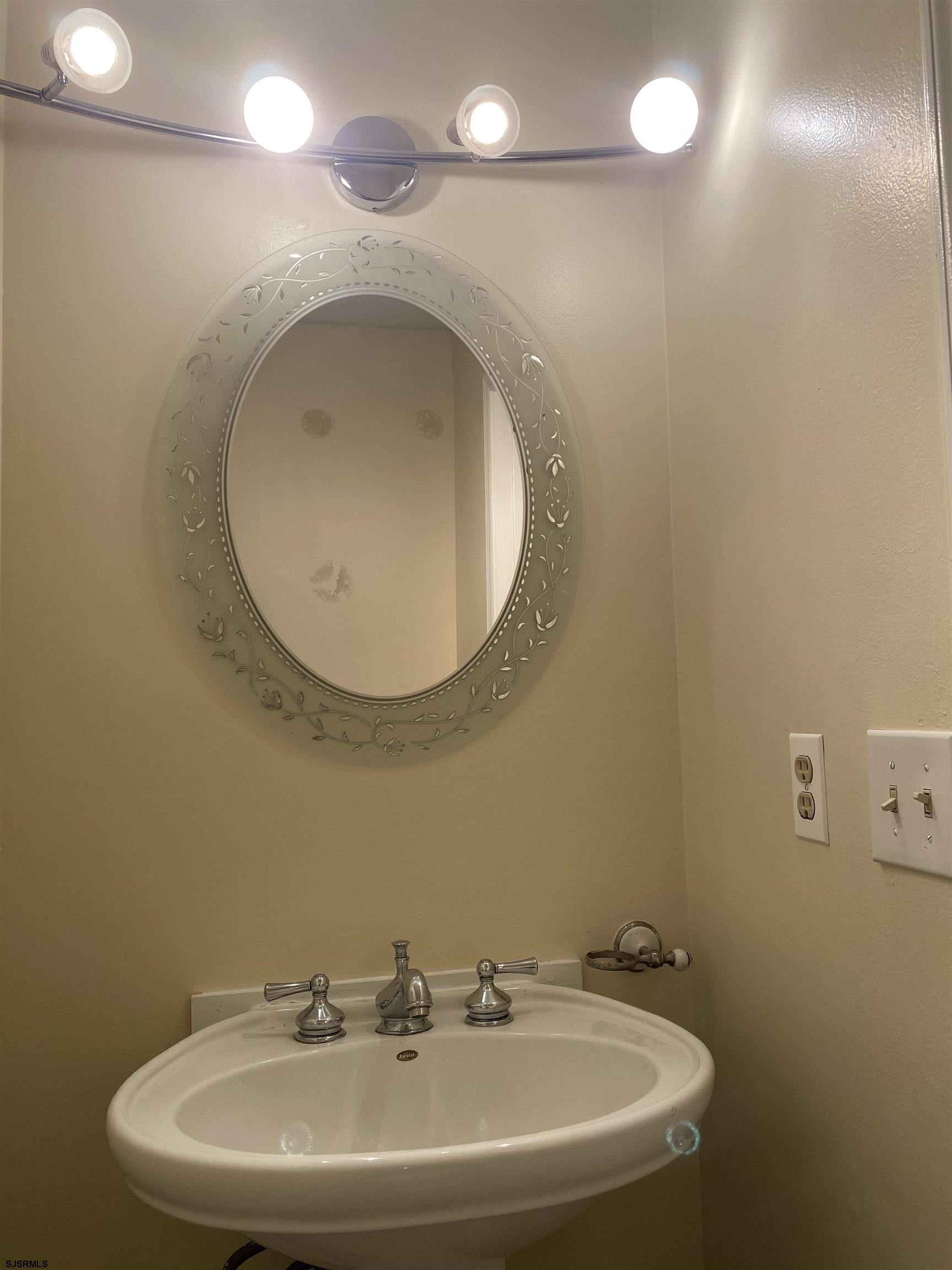 66 Shawnee Place, Unit 66 Galloway Township, NJ 08205 - Photo 8 of 20 a bathroom with a sink a mirror and a toilet