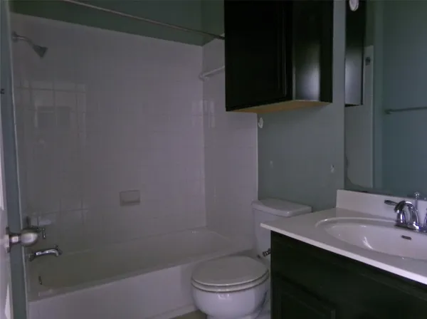 a bathroom with a sink a toilet a mirror and vanity