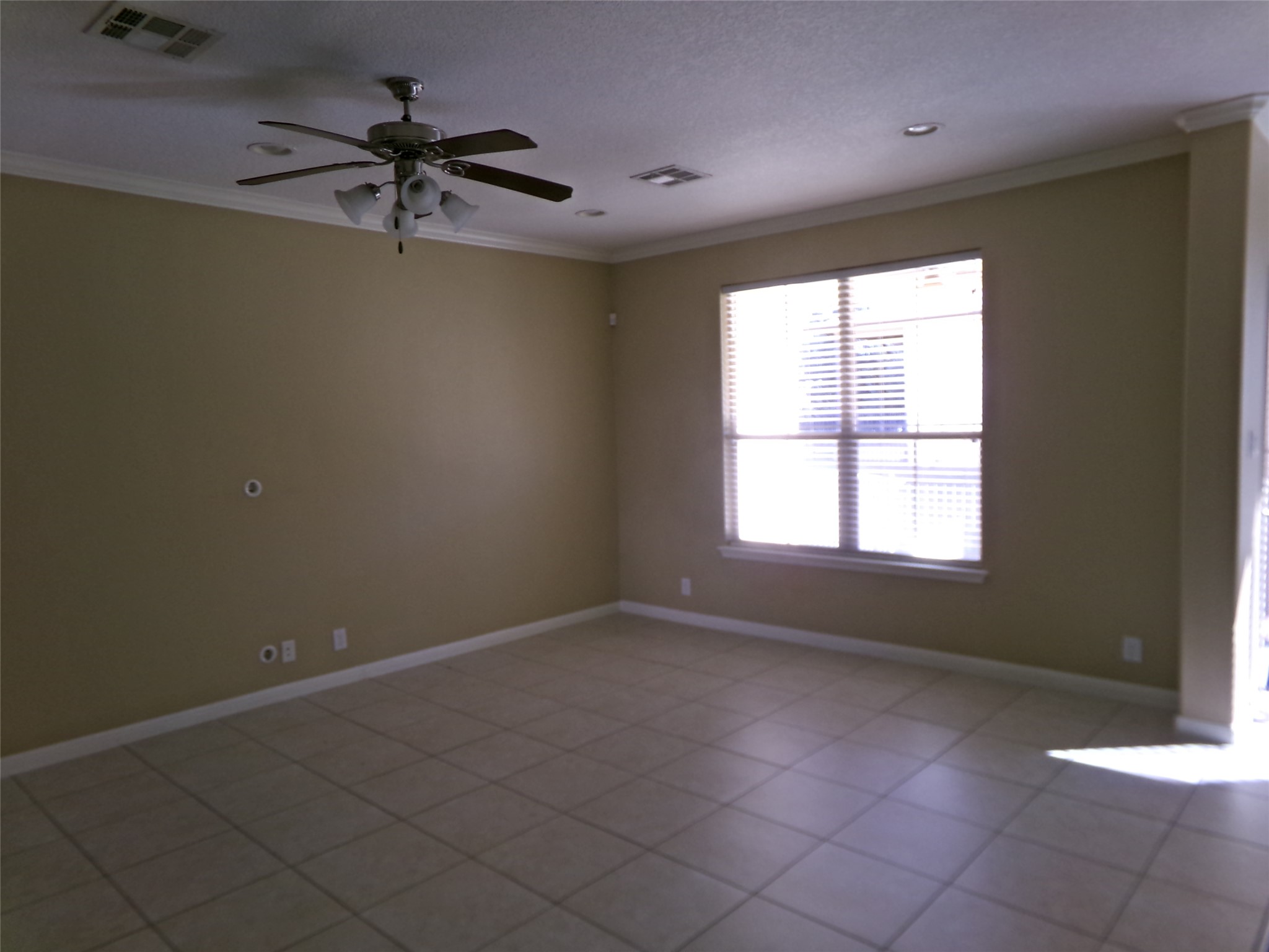14001 Avery Ranch Boulevard, Unit 2103 Austin, TX 78717 - Photo 3 of 21 an empty room with a window and a fan