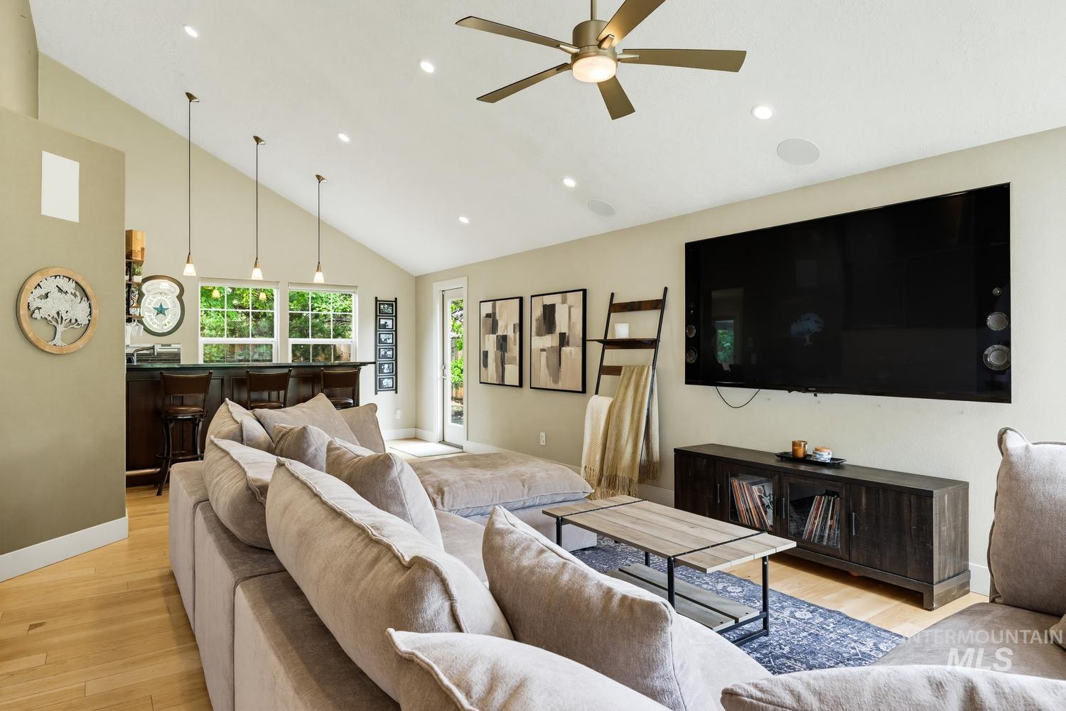 369 South Winthrop Way Boise, ID 83709 - Photo 4 of 50 Vaulted ceiling living area featuring recessed lighting, a ceiling fan, and light wood-finish flooring