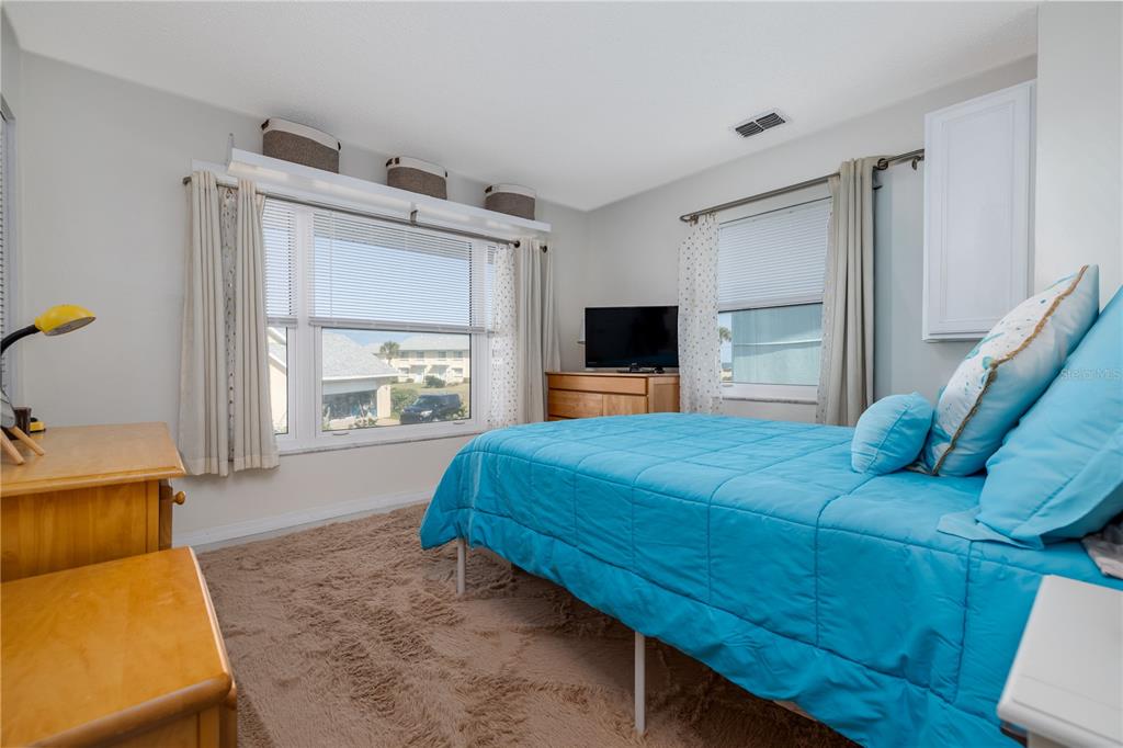 4786 South Atlantic Avenue, Unit B1 Ponce Inlet, FL 32127 - Photo 15 of 22 a bed room with a bed and a television