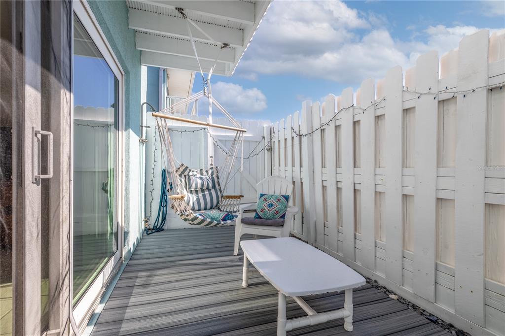4786 South Atlantic Avenue, Unit B1 Ponce Inlet, FL 32127 - Photo 19 of 22 a view of a balcony with chairs and wooden floor