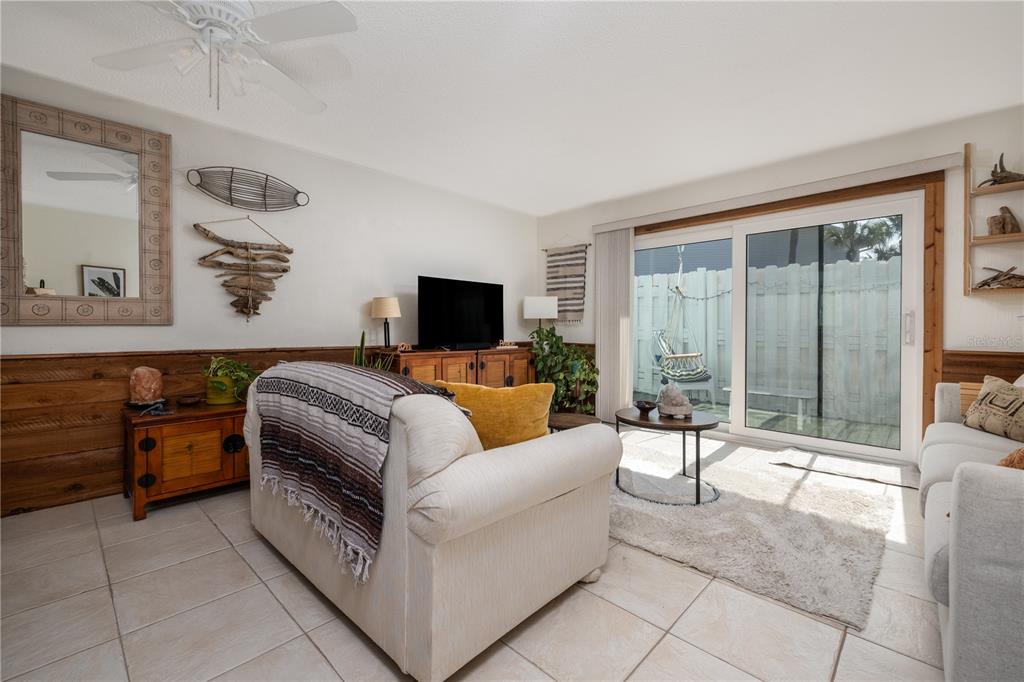 4786 South Atlantic Avenue, Unit B1 Ponce Inlet, FL 32127 - Photo 6 of 22 a living room with furniture and a floor to ceiling window