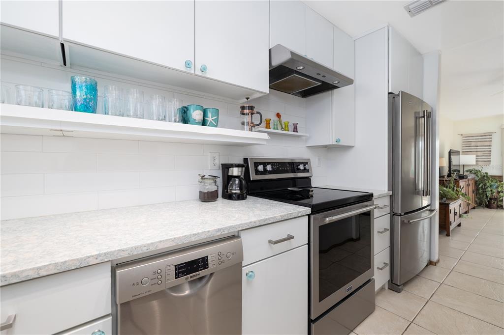 4786 South Atlantic Avenue, Unit B1 Ponce Inlet, FL 32127 - Photo 7 of 22 a kitchen with stainless steel appliances a sink and cabinets