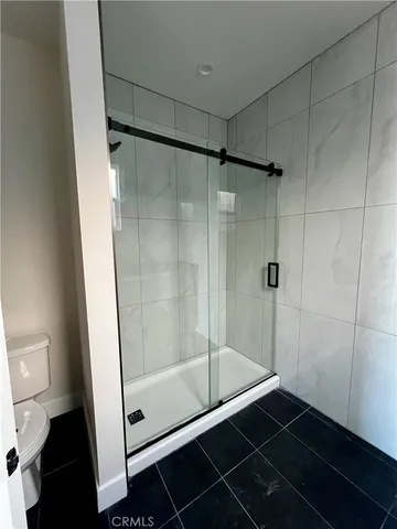 a bathroom with a glass shower door
