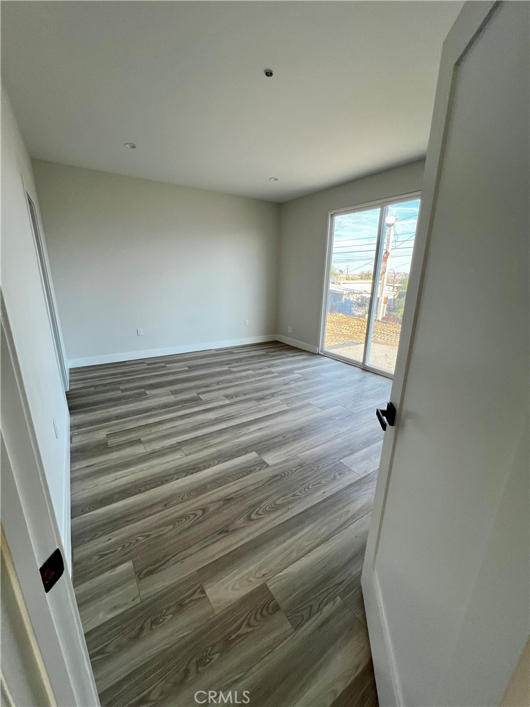 66231 3rd Street Desert Hot Springs, CA 92240 - Photo 12 of 13 a view of an empty room with wooden floor and a window
