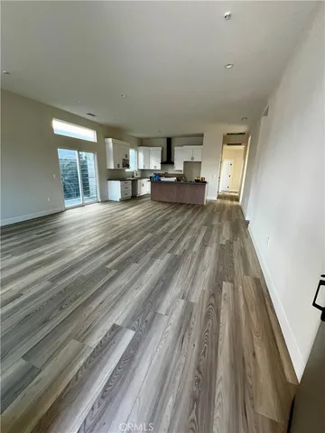 a view of a living room hardwood and kitchen