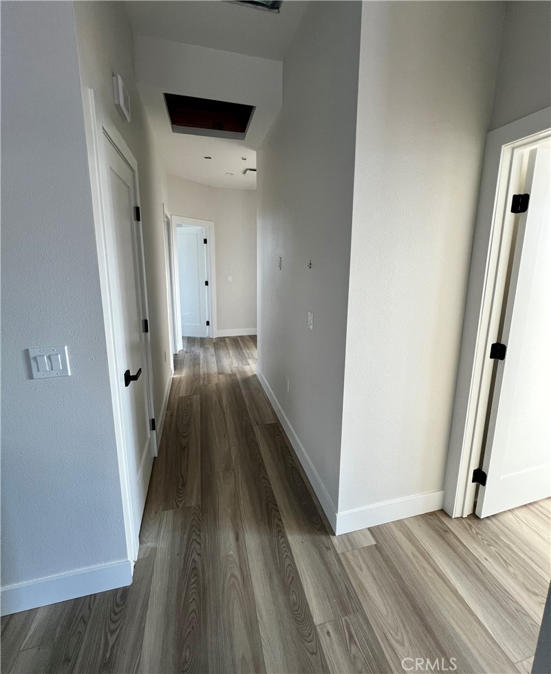 66231 3rd Street Desert Hot Springs, CA 92240 - Photo 6 of 13 a view of a hallway with wooden floor and staircase