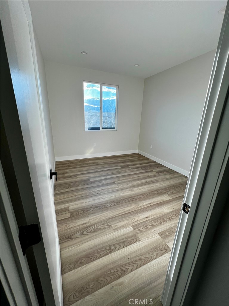66231 3rd Street Desert Hot Springs, CA 92240 - Photo 8 of 13 a view of empty room with wooden floor
