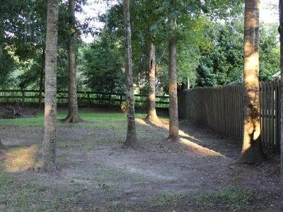 a view of a chair and table in backyard of the house