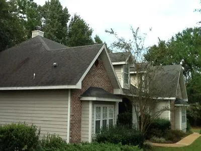 a view of a house with a large window and plants