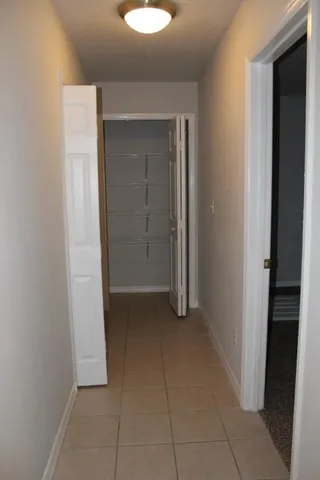 a view of a porch with wooden floor and door
