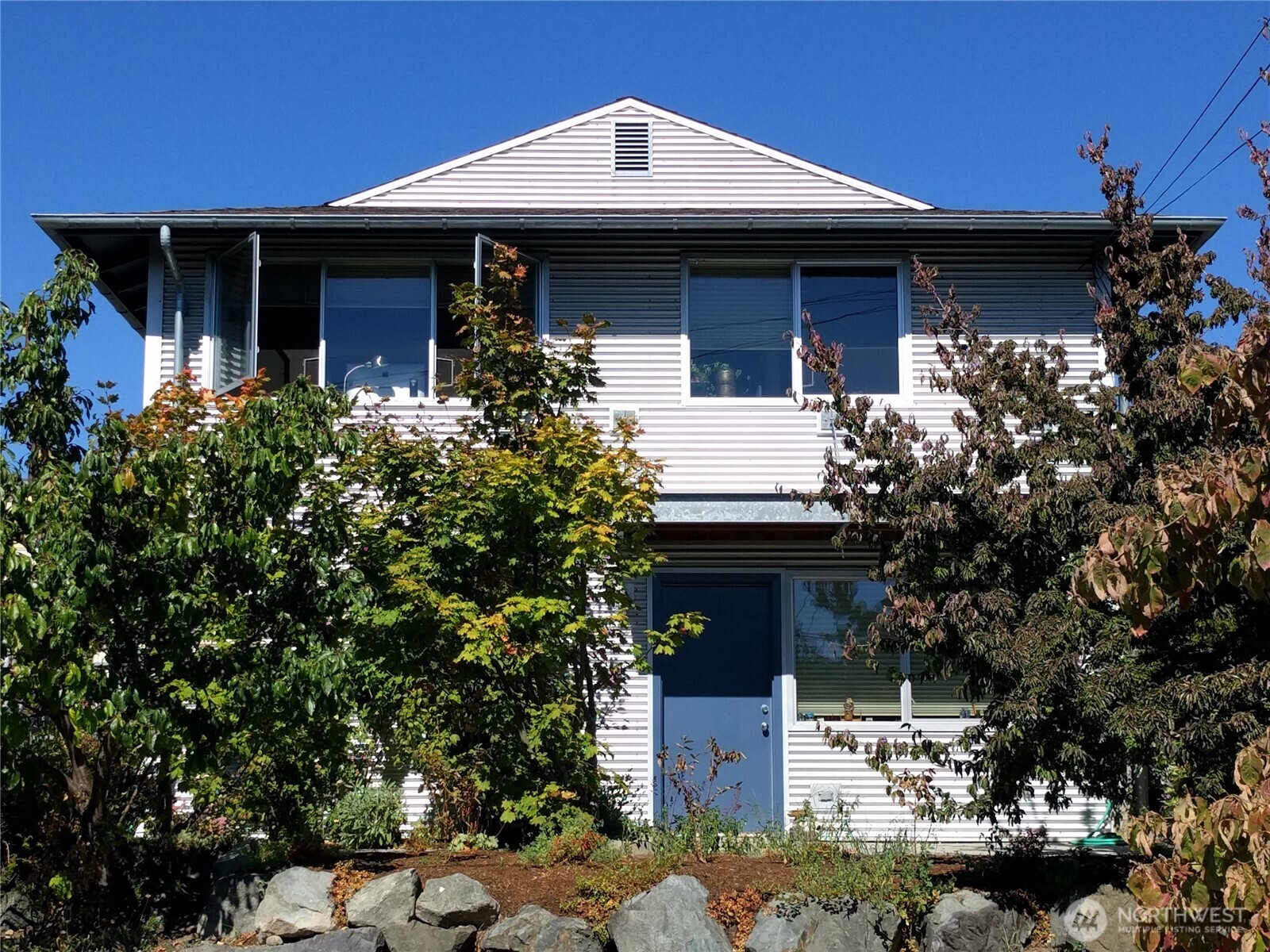 a front view of a house with garden