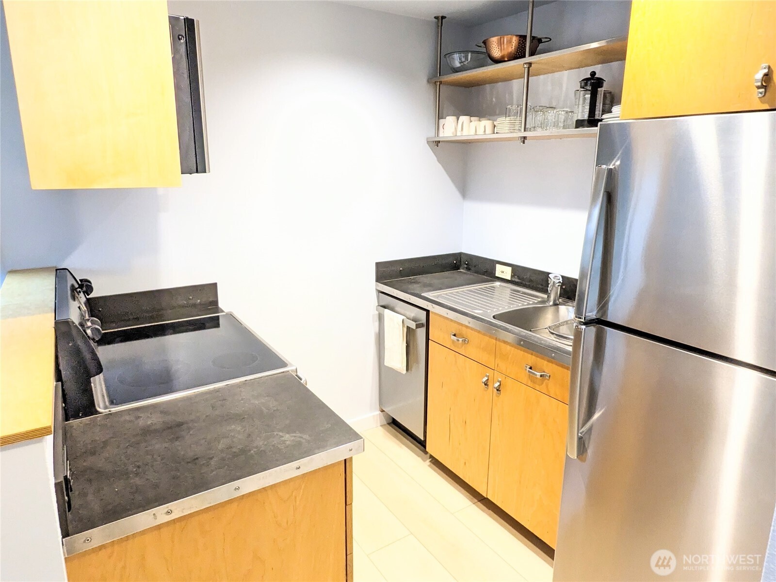 1822 South King Street, Unit AD Seattle, WA 98144 - Photo 11 of 11 a kitchen with stainless steel appliances granite countertop a refrigerator a stove and a sink with wooden floor