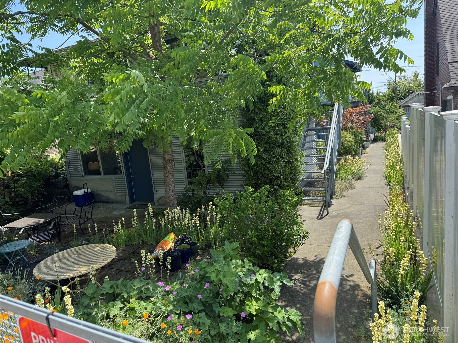 1822 South King Street, Unit AD Seattle, WA 98144 - Photo 2 of 11 a backyard of a house with outdoor seating and green space
