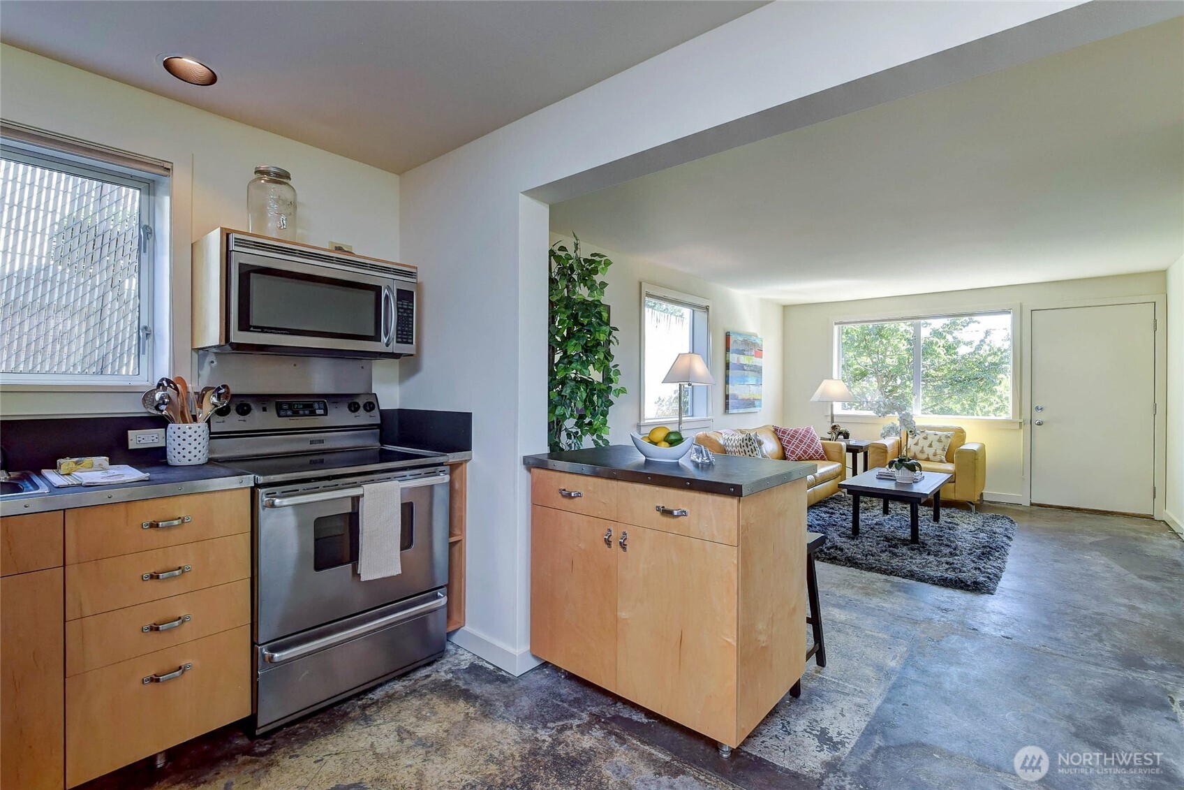 1822 South King Street, Unit AD Seattle, WA 98144 - Photo 8 of 11 a kitchen with a stove and a microwave