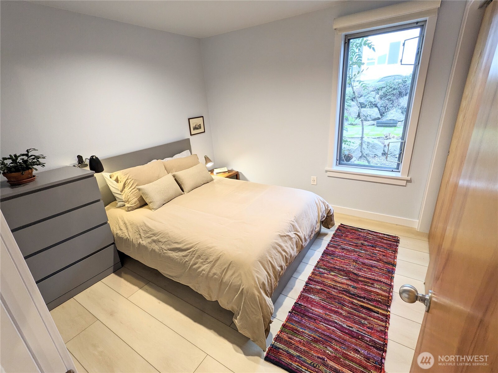 1822 South King Street, Unit AD Seattle, WA 98144 - Photo 10 of 11 a bed sitting in a bedroom next to a window