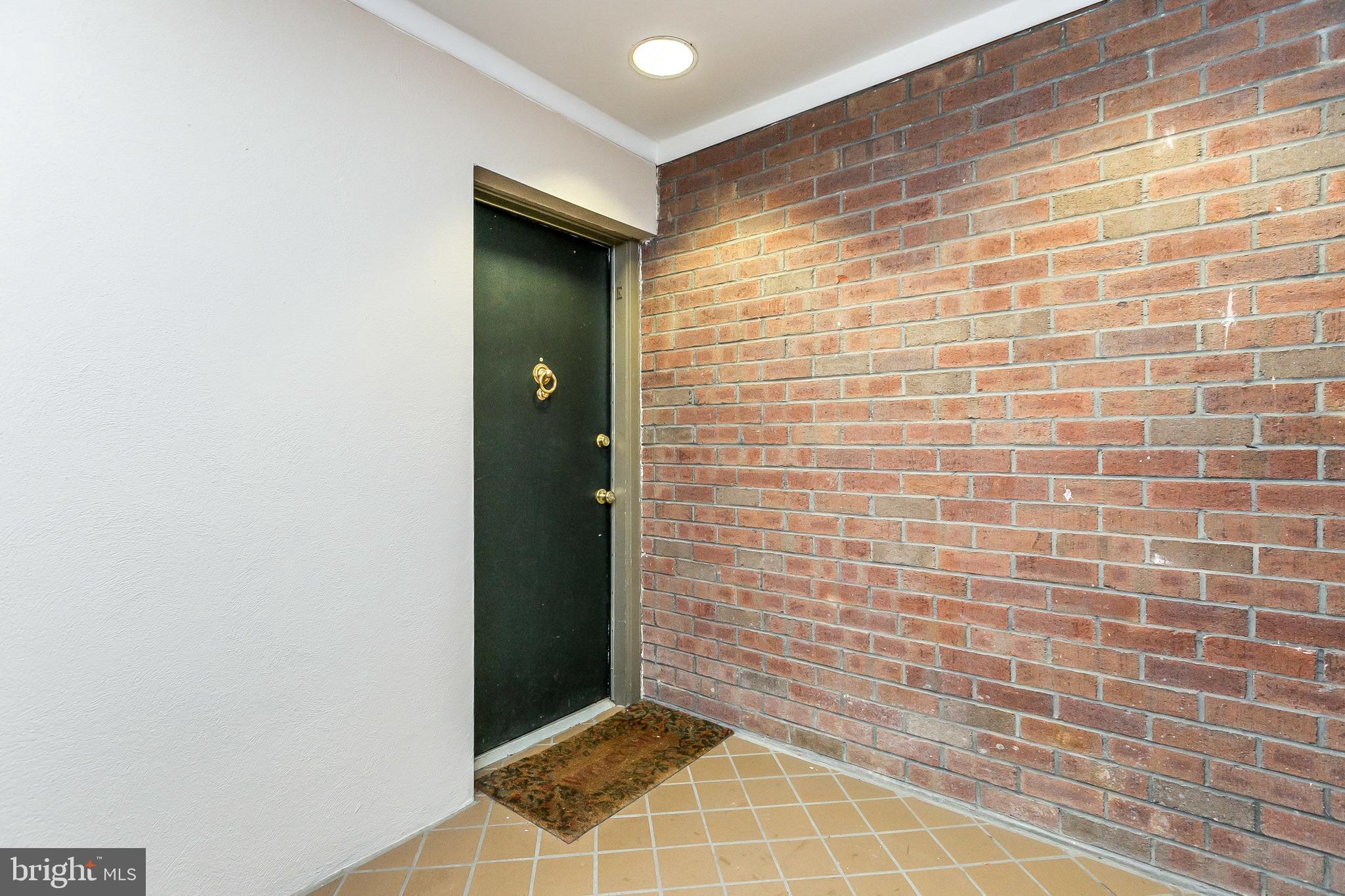 114 Cross Keys Road, Unit R114E Baltimore, MD 21210 - Photo 2 of 33 a view of an empty room with brick walls