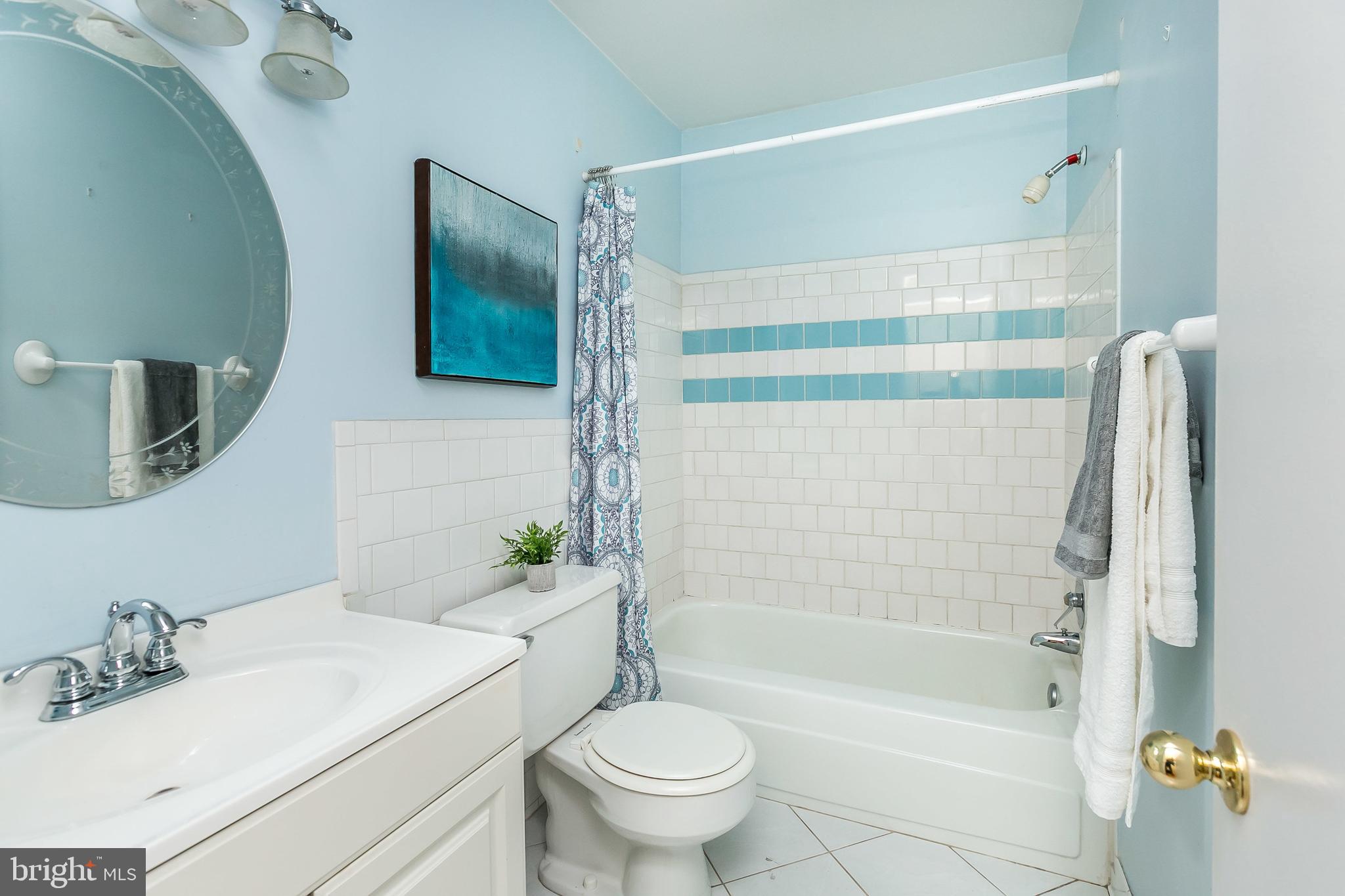 114 Cross Keys Road, Unit R114E Baltimore, MD 21210 - Photo 20 of 33 a bathroom with a sink toilet and shower