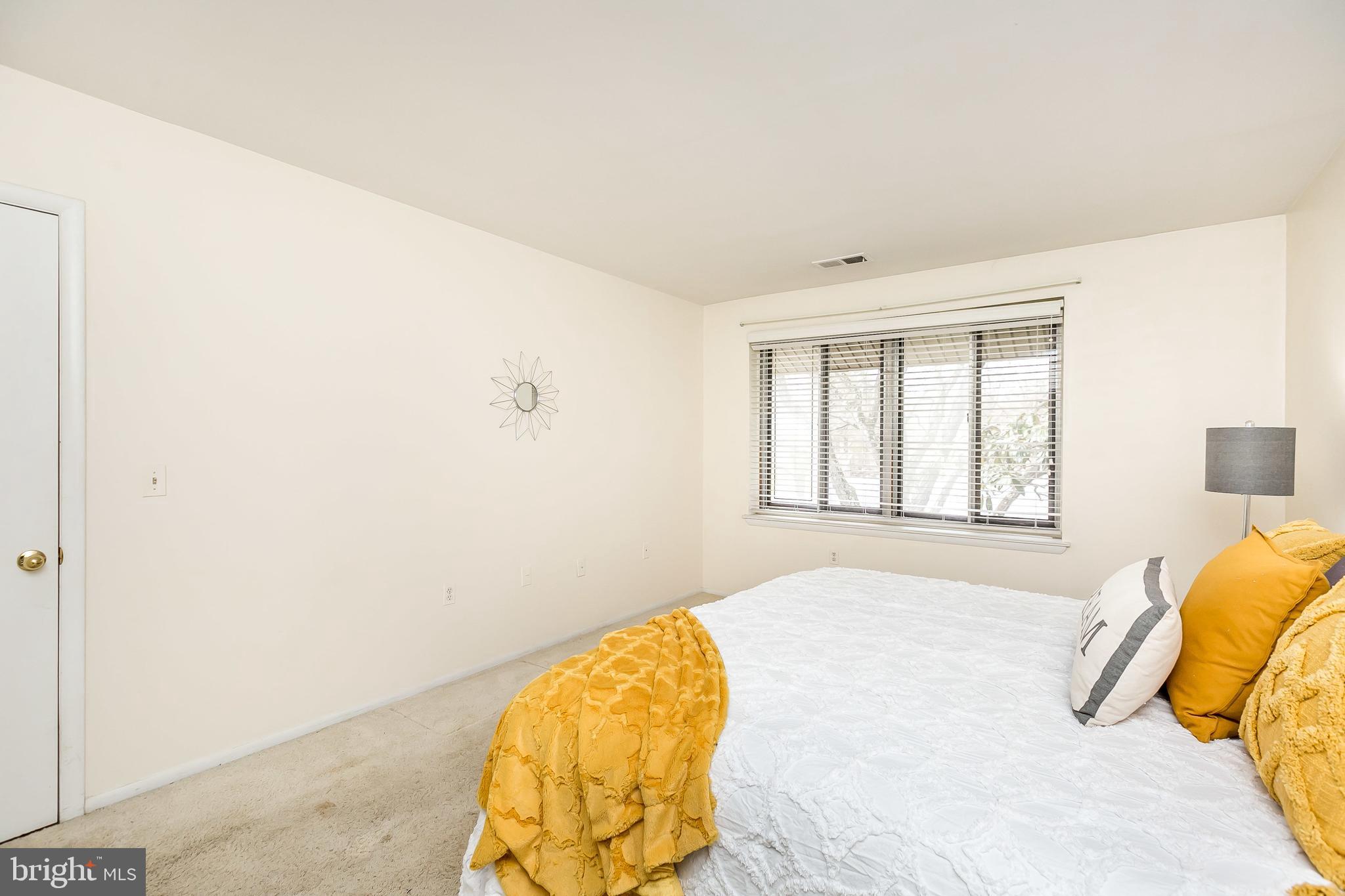 114 Cross Keys Road, Unit R114E Baltimore, MD 21210 - Photo 23 of 33 a bedroom with a bed and a window