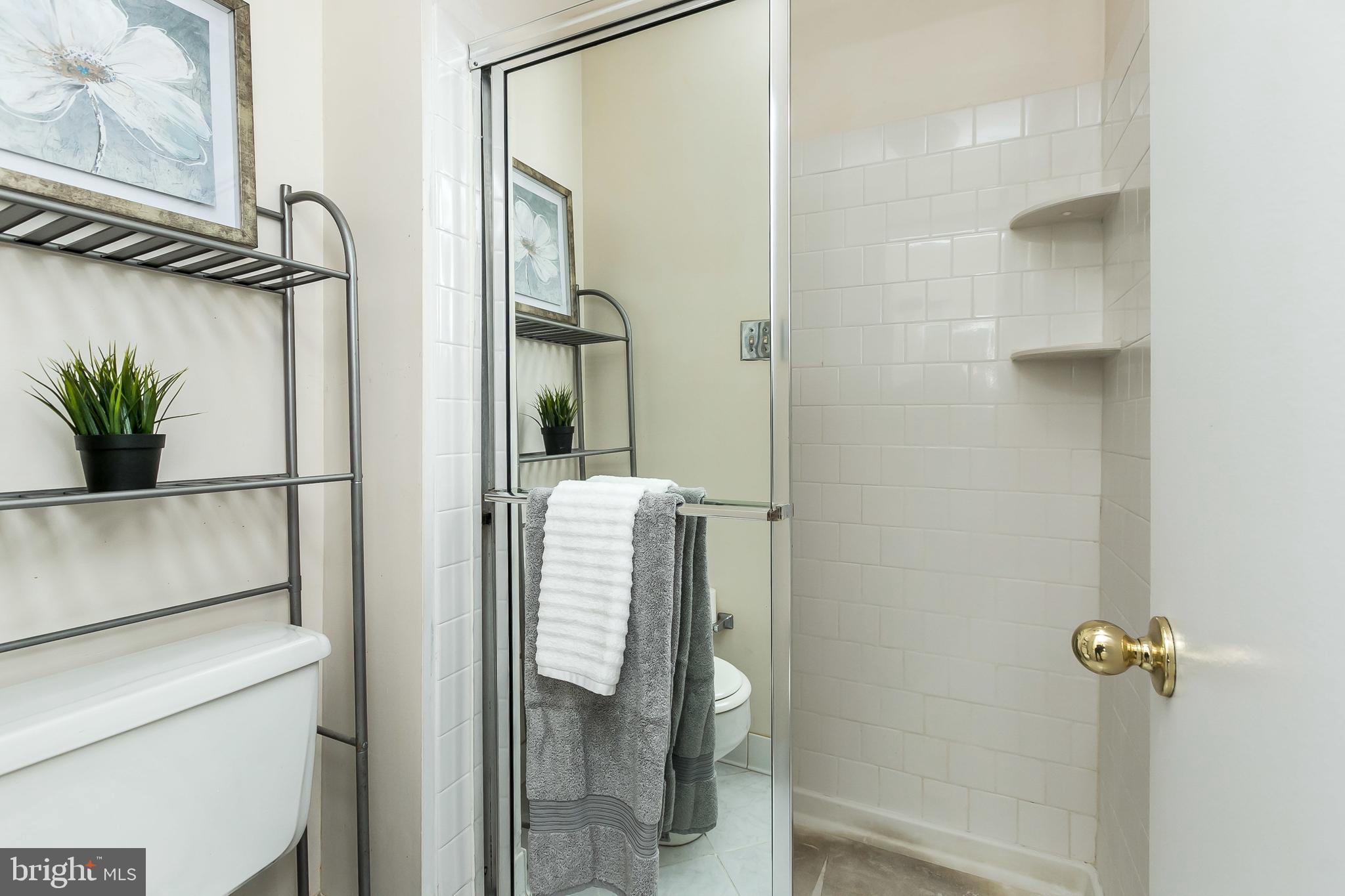 114 Cross Keys Road, Unit R114E Baltimore, MD 21210 - Photo 26 of 33 a bathroom with a shower and a sink