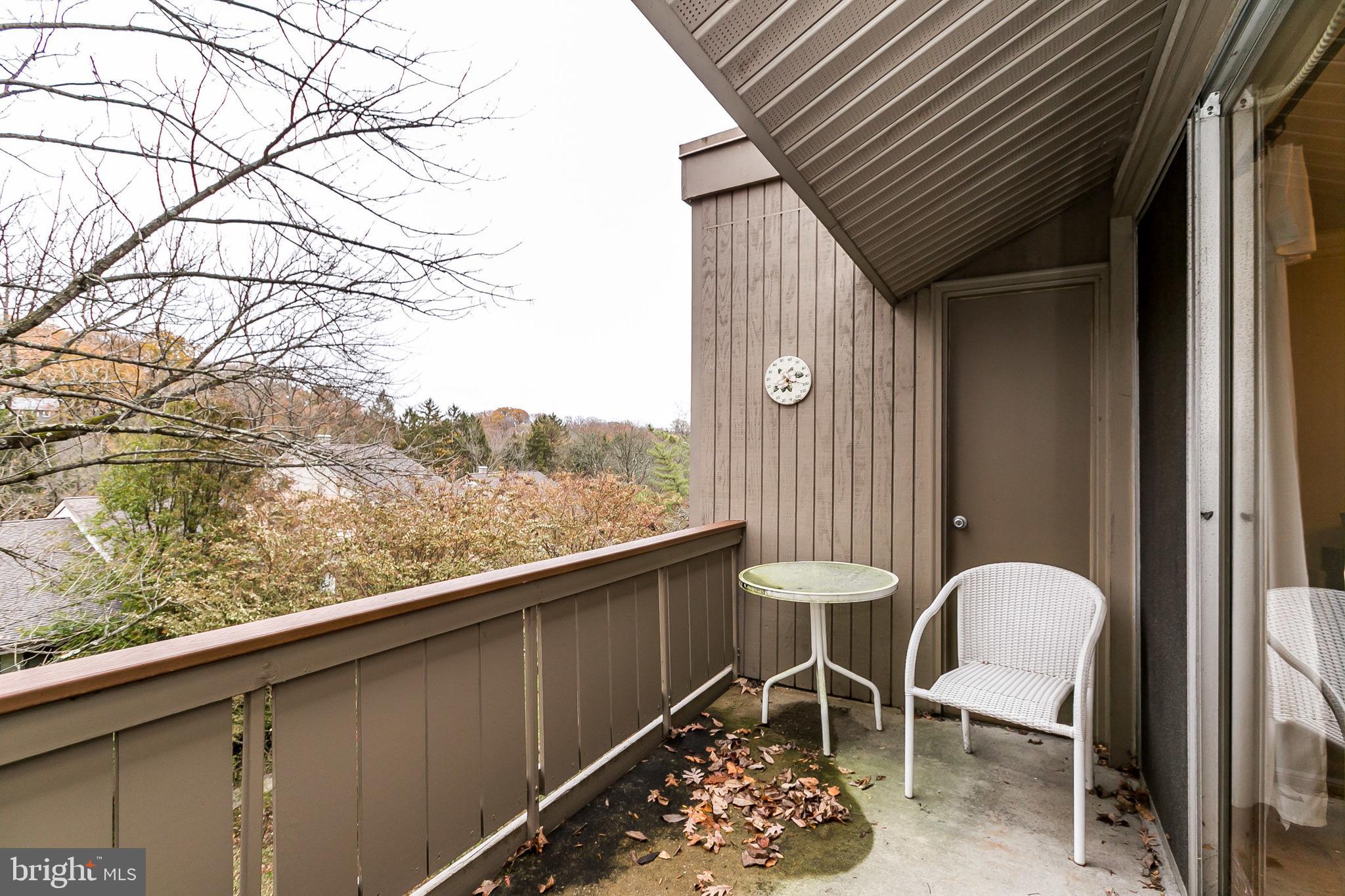 114 Cross Keys Road, Unit R114E Baltimore, MD 21210 - Photo 28 of 33 a balcony with table and chairs
