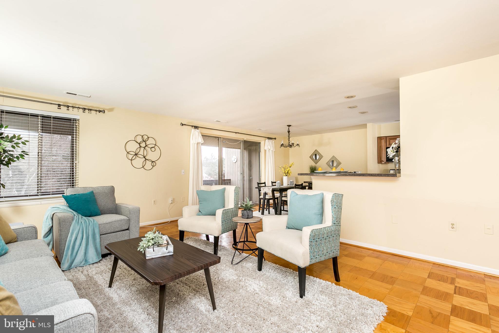 114 Cross Keys Road, Unit R114E Baltimore, MD 21210 - Photo 6 of 33 a living room with furniture and a table